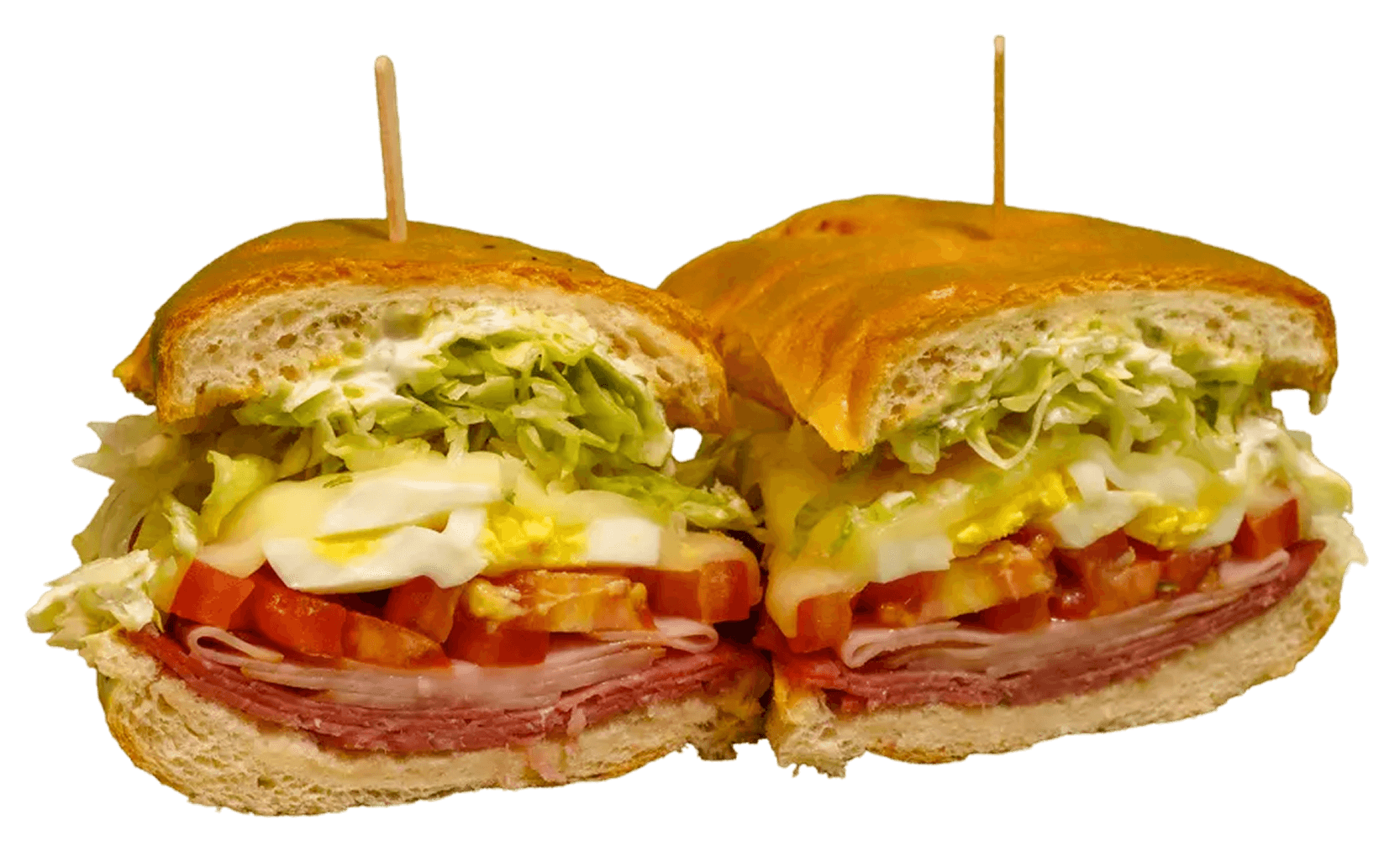 A large sandwich, cut in half and held by toothpicks, reveals layers of shredded lettuce, hard-boiled egg, diced tomatoes, and sliced deli meats on a crusty roll.