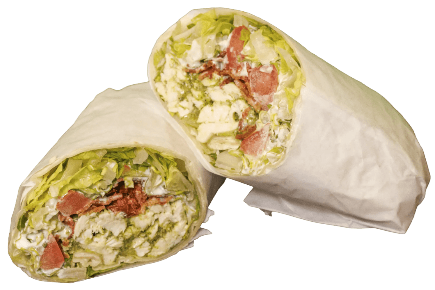 A chicken pesto wrap cut in half, revealing a cross-section of fresh lettuce, white meat, green pesto, red tomatoes, and bacon bits, wrapped in white paper.